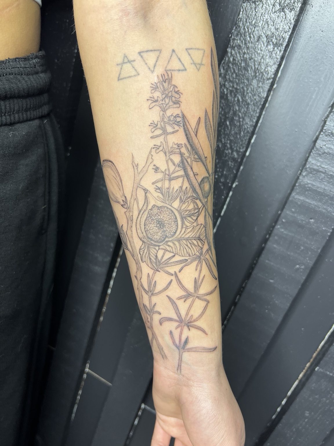 Botanical arm tattoo