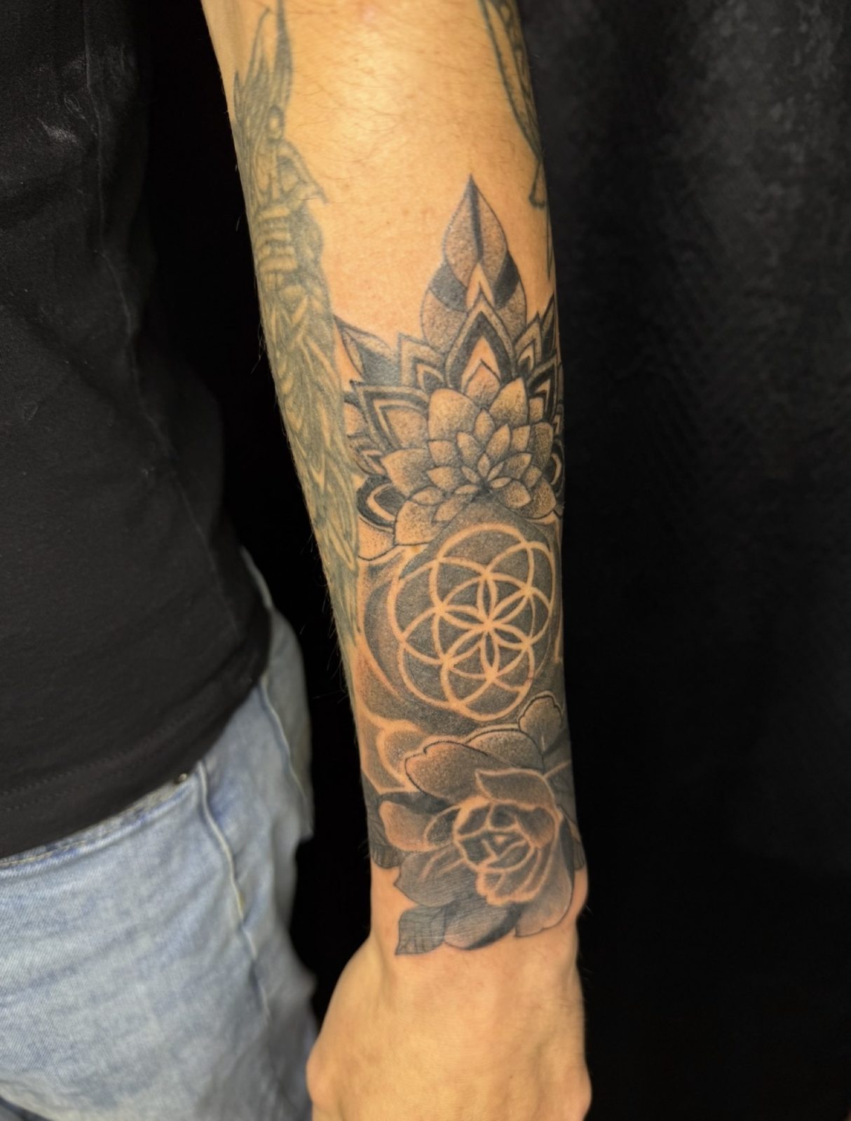 Ornamental forearm piece with a mandala, seed of life and rose